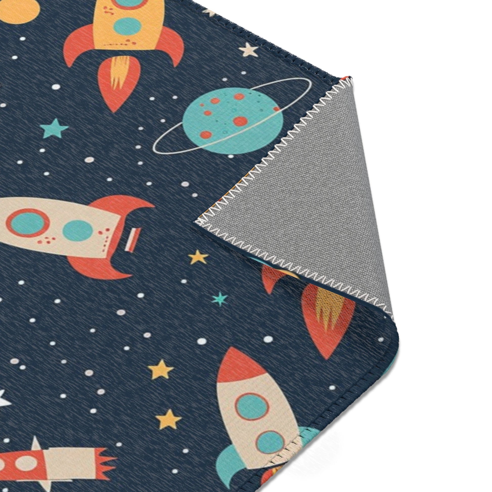 Kinderteppich „Weltraumchaos“ von spielzwerg. Nahaufnahme umgeklappte Ecke. RUG-00155-XL, RUG-00155-L.