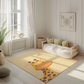 Kinderteppich "Gerda Giraffe" von spielzwerg. Ambientebild von einem hellen, freundlichen Kinderzimmer mit weißen Holzwänden und hellem Holzboden. In der Ecke steht ein niedriges Holzbett mit weißen Decken und hellgrünen Kissen. Davor liegt der Teppich. Links steht ein kleines Holzspielzeugrad am Fenster mit weißen Vorhängen. An der Wand hängt ein gerahmtes Bild mit einem dezenten, kreisförmigen Muster. RUG-00126-XL, RUG-00126-L.